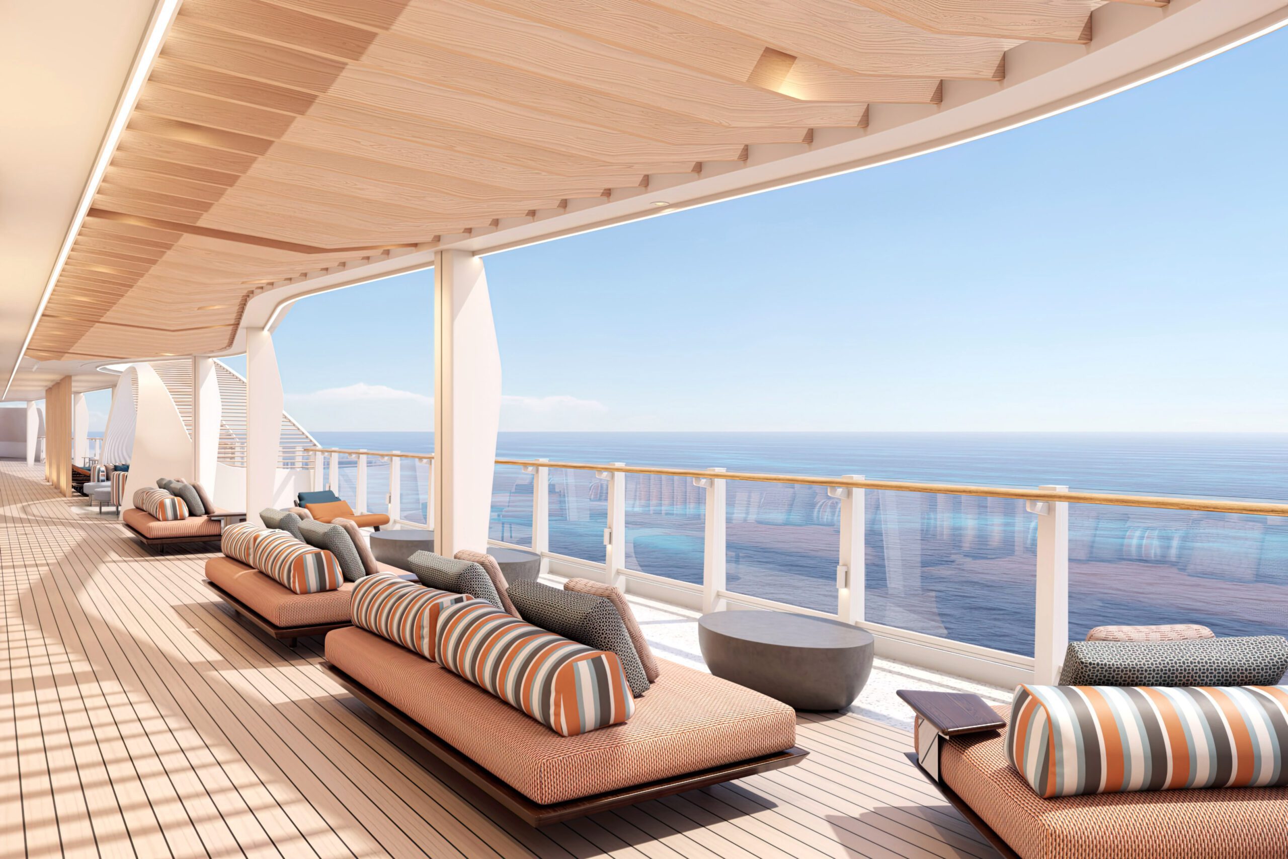Cruise ship deck with lounge chairs overlooking the ocean.