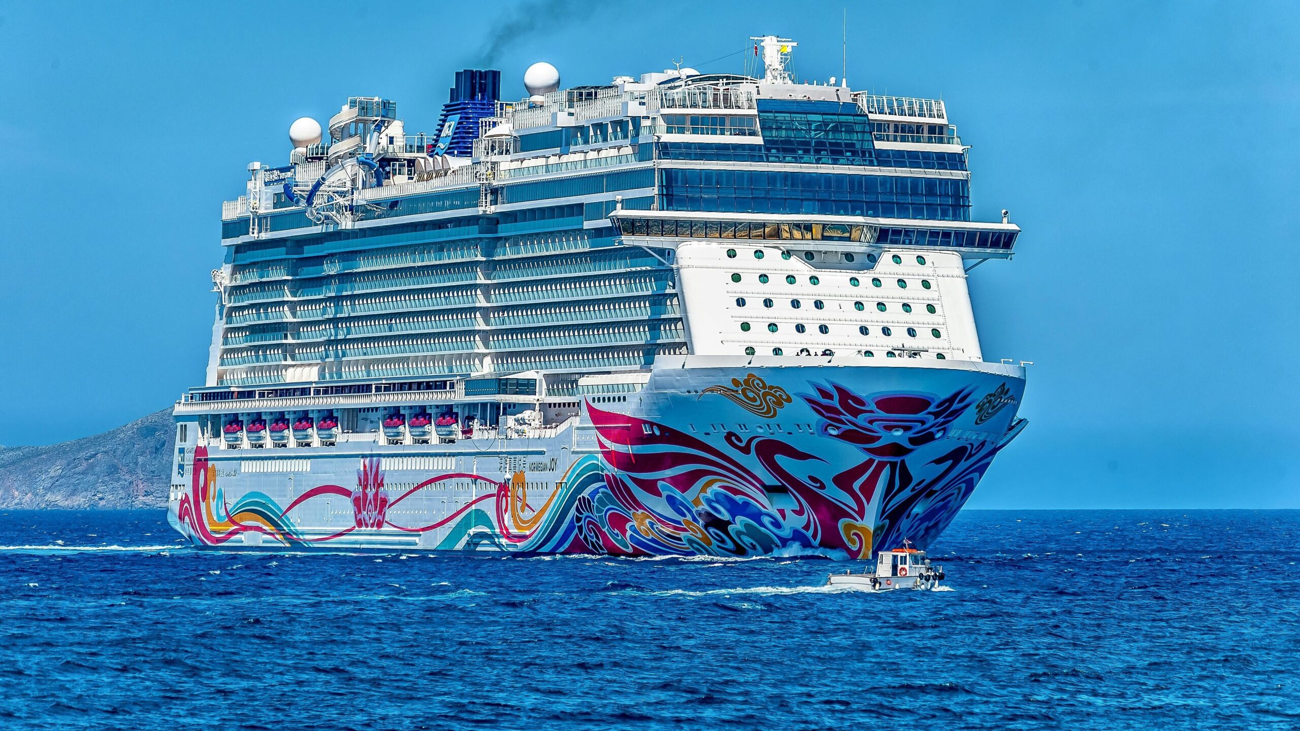 A majestic cruise ship gliding across a sparkling turquoise ocean, promising an unforgettable vacation.