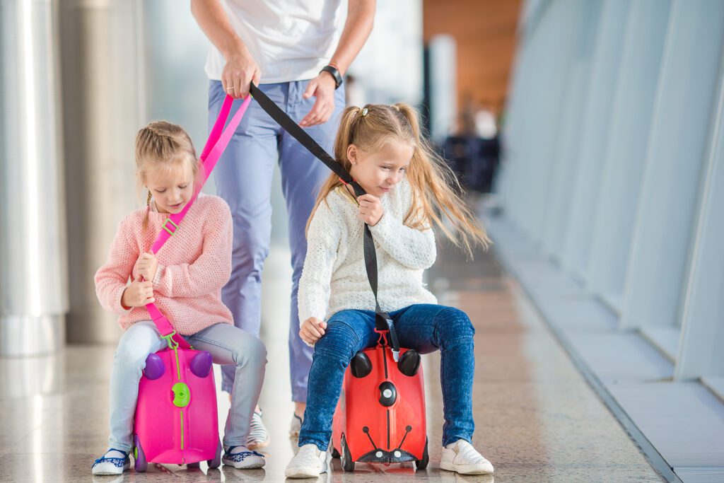 Two young girls waiting at an airport