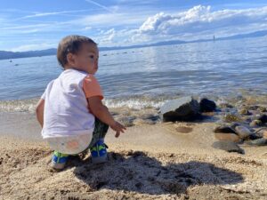 Toddler sitting on a Lake Tahoe beach