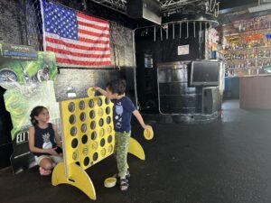Kids playing a giant connect-four game, Daytona Beach, Florida