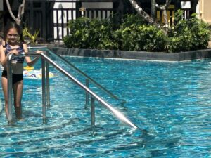 Two children in a resort swimming pool, Krabi, Thailand