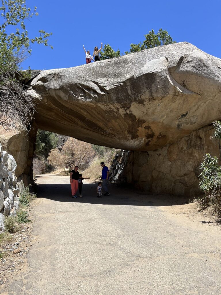 Huge balanced granite boulder forming an arch over a trail in the Sierra foothills near Three Rivers