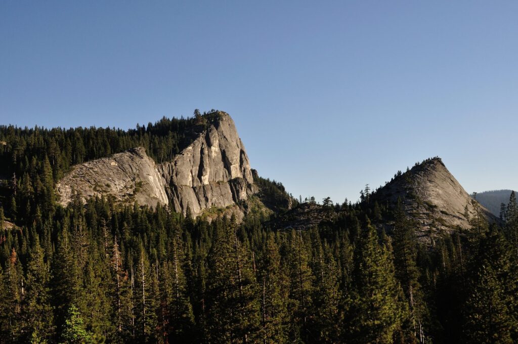 Granite domes rising above pine forest at dusk in the Lake Tahoe area