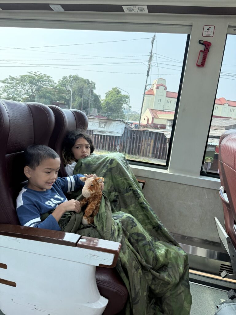 Kids on the train from Surabaya to Yogyakarta, Java, Indonesia