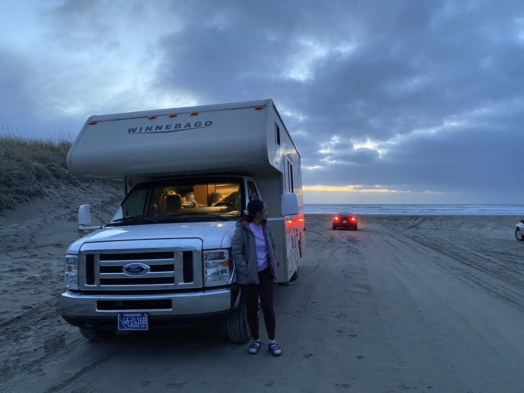 Motorhome parked on the beach at dusk near Warrenton, Oregon