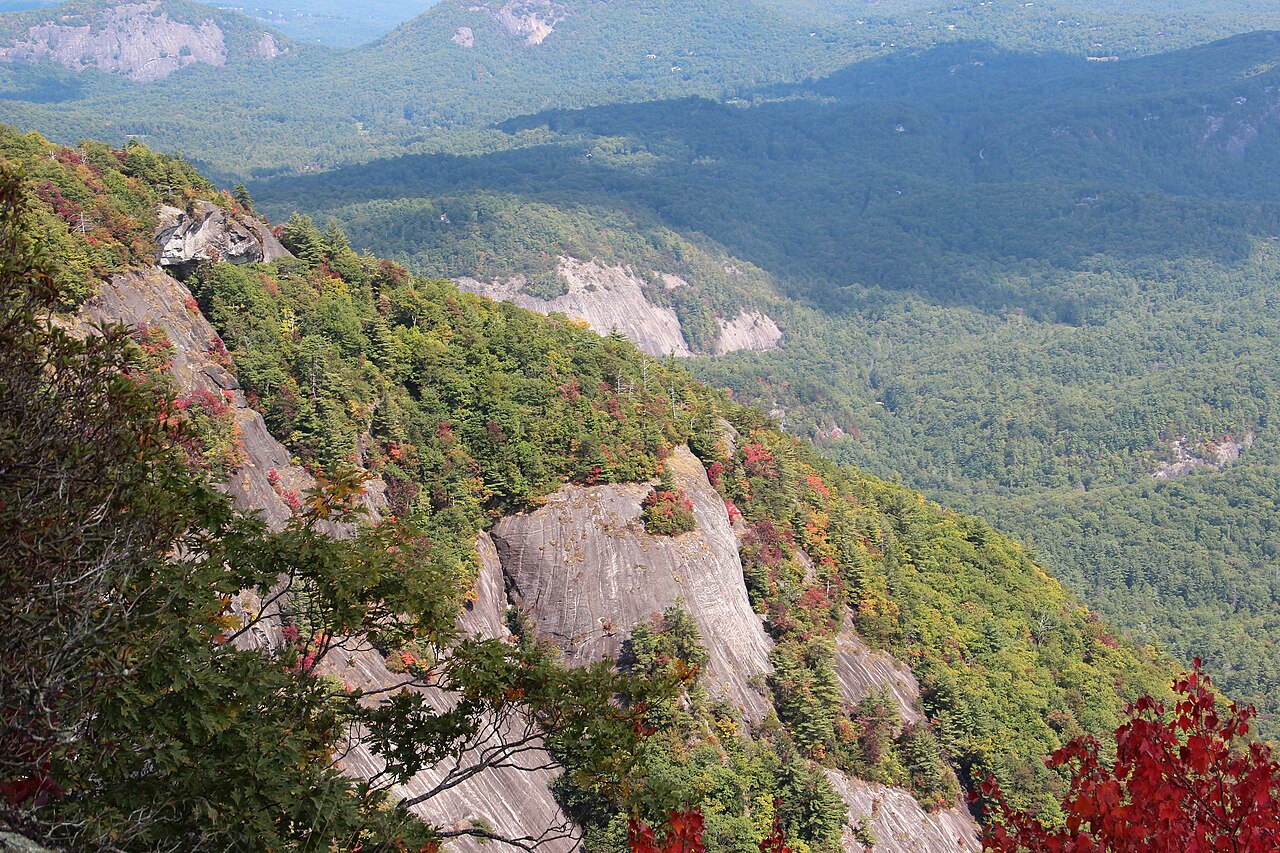 Granite cliffs of Whiteside Mountain above a forested valley in fall, near Highlands, North Carolina